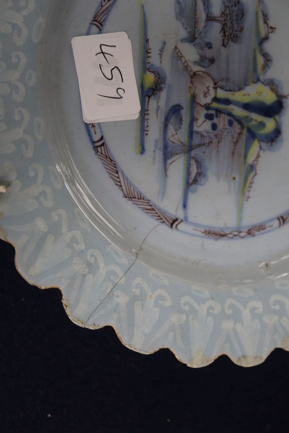 A Bristol Delft petal rimmed dish with Bianco Sopra Bianco border, diameter 22cm, cracked